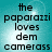 A static image with pixelated text reading "the paparazzi loves dem camerass" on a teal background.