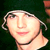 Static 50x50 pixel icon showing a close-up of a person's face with light skin, dark hair, and a black choker necklace against a dark green background.