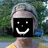 A pixelated image of a person with a black square covering their face, displaying a white smiley face, with text reading 'in love' and 'With Him' in separate sections.