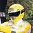 Pixelated static image of a figure with light-colored hair wearing dark sunglasses and a yellow top against a blurred background.