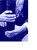 Animated sequence showing a blue-toned hand holding a cup, transitioning to a sepia-toned building exterior with a tower, then to a red-columned colonnade.