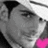 Pixelated grayscale portrait of a person with dark hair and a white headband on left, pink and gray background with pixelated text on right.