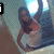 A pixelated image of a person in a light-colored dress with a red top, seated on stairs with a bright light source behind them, overlaid with text elements.