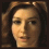 three pixelated images showing a person with brown hair in different facial expressions against dark backgrounds