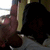 Pixelated image of a person with dark hair and a light-colored sleeve, partially visible against a blurred background.