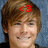 Pixelated portrait of a person with light brown hair against a blue background, featuring a red '<3' symbol on the forehead.