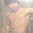 A pixelated image of a shirtless person with light skin and short hair, positioned against a blurred background.
