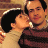 Static 48x48 pixel buddy icon showing a close-up of two people kissing, with visible facial features and clothing details in warm tones.