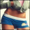 Static image of a person's midsection wearing blue shorts with white stripes and a gray hoodie, cropped to show torso only.