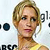 Pixelated close-up of a person with short blonde hair wearing a yellow top against a light background with partial text fragments.