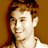 Static pixelated image of a person with light brown hair and fair skin against a solid brown background, rendered in low-resolution 256x256 pixels.