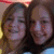 Two people with brown hair smiling closely together on the left, next to a bright pink background with stacked text reading "Lizz & Emm Dever!" on the right.
