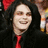 A pixelated image of a person with long dark hair and red tie, next to blue text reading 'bad to nice into your I love' on black background.