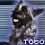 Pixelated character icon with dark fur, white eye patch, and blue striped background featuring 'TOTO' text at bottom.