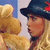 A pixelated animated icon shows a blonde woman in profile wearing a black hat with red accents, facing left against a blue and white background.