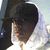 A person wearing a black cap and white hoodie appears in four showing slight head movement