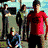 A pixelated group of people in two , with some individuals wearing red and black clothing against a light background