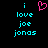 Pixelated cyan text reads 'i love joe jonas' on black background with a pink heart symbol above the first line.