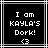 Black background with white pixelated text reading "I am KAYLA'S Dork!" and a heart symbol below, framed by gray and white lines