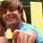 Pixelated image of a person in blue clothing holding yellow objects against a dark background, with red text on a blue reading "Zac Efron Wants Morgan <3"
