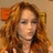 Pixelated close-up of a person with long wavy brown hair, closed eyes, and light skin tone against a beige background.