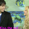 A static image shows two people smiling at each other against a backdrop of a fish and ocean scene with pink text reading 'Kiss the Girl' at the bottom.
