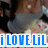 A pixelated image shows a person in dark clothing holding a child in a colorful outfit, with blue text reading 'iLOVELil' at the bottom.