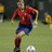A pixelated image shows a person in a red jersey and blue shorts kicking a soccer ball on a grassy field, with red text reading "Mia Hamm" on the right.