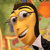 Pixelated cartoon character with yellow skin, dark hair, and a wide grin holding a blue object near a yellow structure.