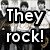 Pixelated static image with bold white text "They rock!" on a black background, overlaid on a blurred grayscale collage of indistinct figures.