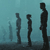 Four silhouetted figures stand against a gradient blue background, varying in height and posture with no visible facial features or clothing details.