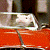 A contact sheet of two animated frames showing a red vehicle with white accents and green text reading "Original Icons .com" on a dark background.