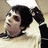 Pixelated image of a person with dark hair in pigtails wearing a light-colored top, next to black background with white text reading "Whaaa Happenn?".