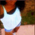 A pixelated image shows a person wearing a white sleeveless top with blue trim, brown hair, and light skin against a blurred background.