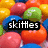 colorful candy-like spheres with text overlays reading 'skittles', 'taste the', and 'rainbow!' in black boxes