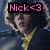 Pixelated image of a person with light hair holding a yellow object, overlaid by pink text reading 'Nick<3' on black background.