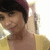A person with short dark hair wearing a maroon headband and yellow top, shown in four -aligned with subtle pose changes