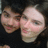 Two pixelated human faces side-by-side on a dark background, both with light skin tones and neutral expressions.
