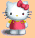 Pixelated Hello Kitty character with red bow, pink dress, and yellow accents on peach background.