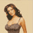 Pixelated static image of a woman with long dark hair wearing a strapless brown dress against a beige background.