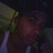 Pixelated image of a person with dark skin wearing a yellow garment, overlaid with white pixelated text reading 'i LOVE MY BOYFRIEN TOYion' on black background.
