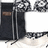 A static pixelated image shows a dark-colored refrigerator with metallic handles and a small brown rectangular label on the door, set against a light background.
