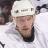 Pixelated image of a hockey player in white uniform with helmet, next to text and team logo on split background.