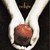A split-screen animation shows a hand holding a brown sphere, red ribbon, and chess pieces against black backgrounds.