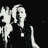Black-and-white animated sequence showing a person with light hair in dark clothing performing repeated hand gestures against a starry background.