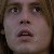 Pixelated close-up of a person's face showing eyes, nose, mouth, and hair with visible pixelation and low resolution.
