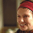 Pixelated static image of a person wearing a red headband and dark clothing against a neutral background with visible dithering and low-resolution rendering artifacts.