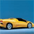 Yellow convertible car with black roof section, blue background, and visible wheels on light blue surface.