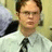 Pixelated static image of a person in a white shirt and dark tie against a light background with blurred shapes.