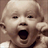 Static 48x48 pixel icon of a baby's face with open mouth, rendered in low-resolution grayscale tones on brown background.